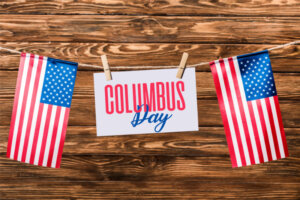 card with Columbus day lettering hanging on string with pins and